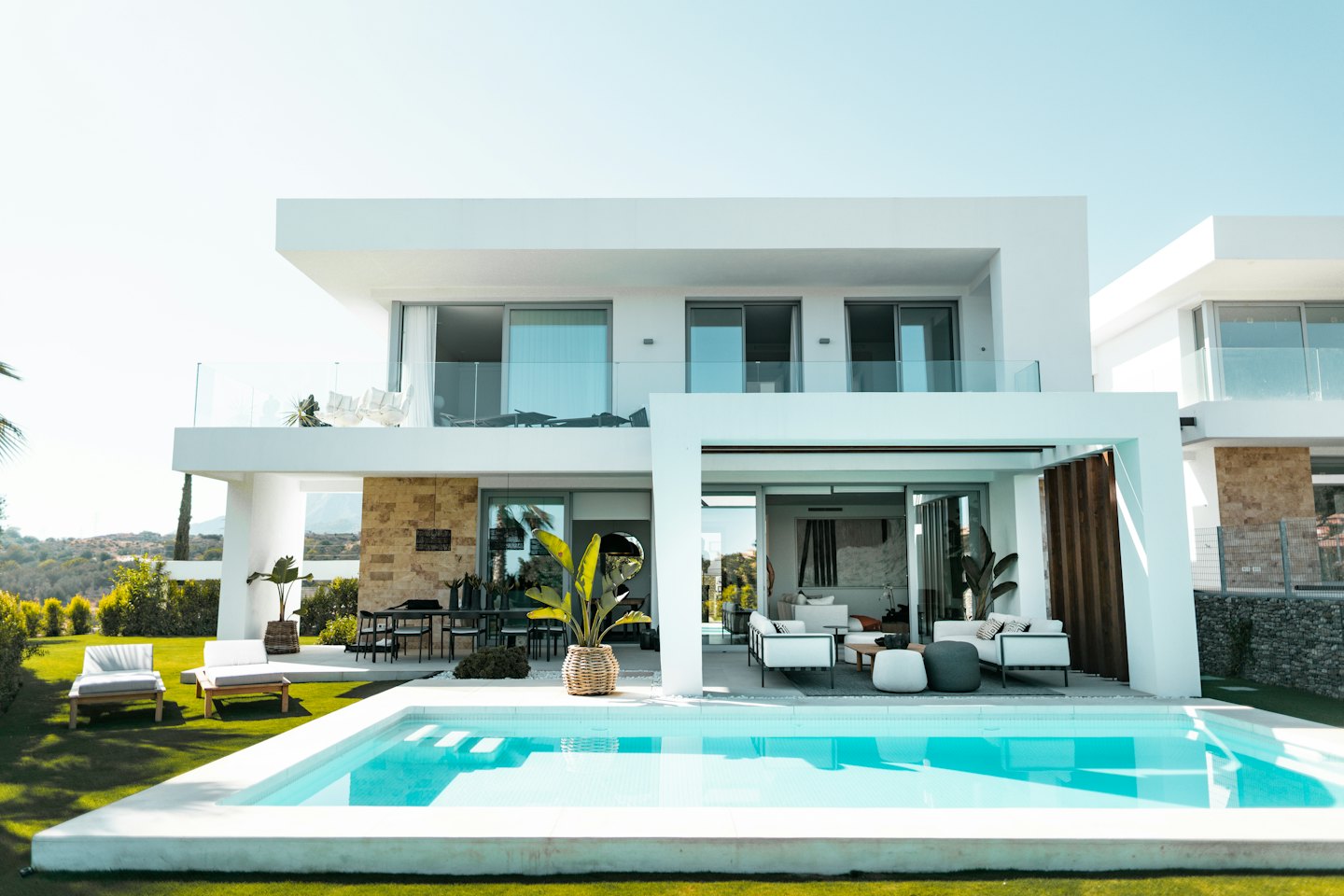 Modern villa with a rectangular pool and outdoor living spaces.