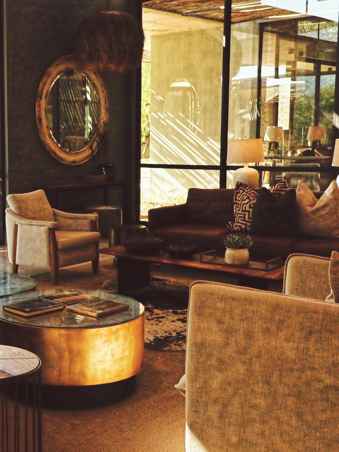 Furnished living room with armchairs, sofas, and coffee tables.
